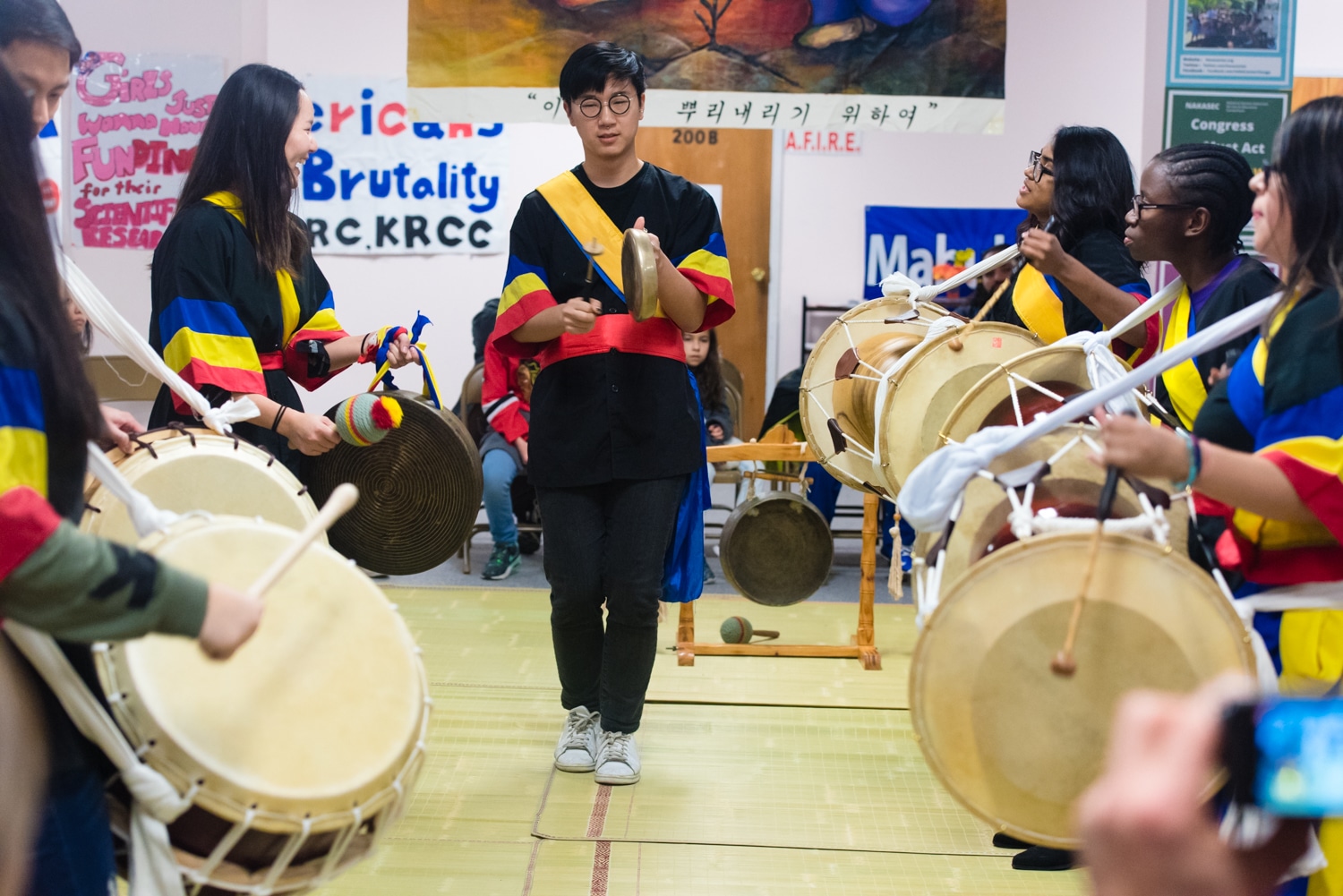 Group of people performing on traditional drums